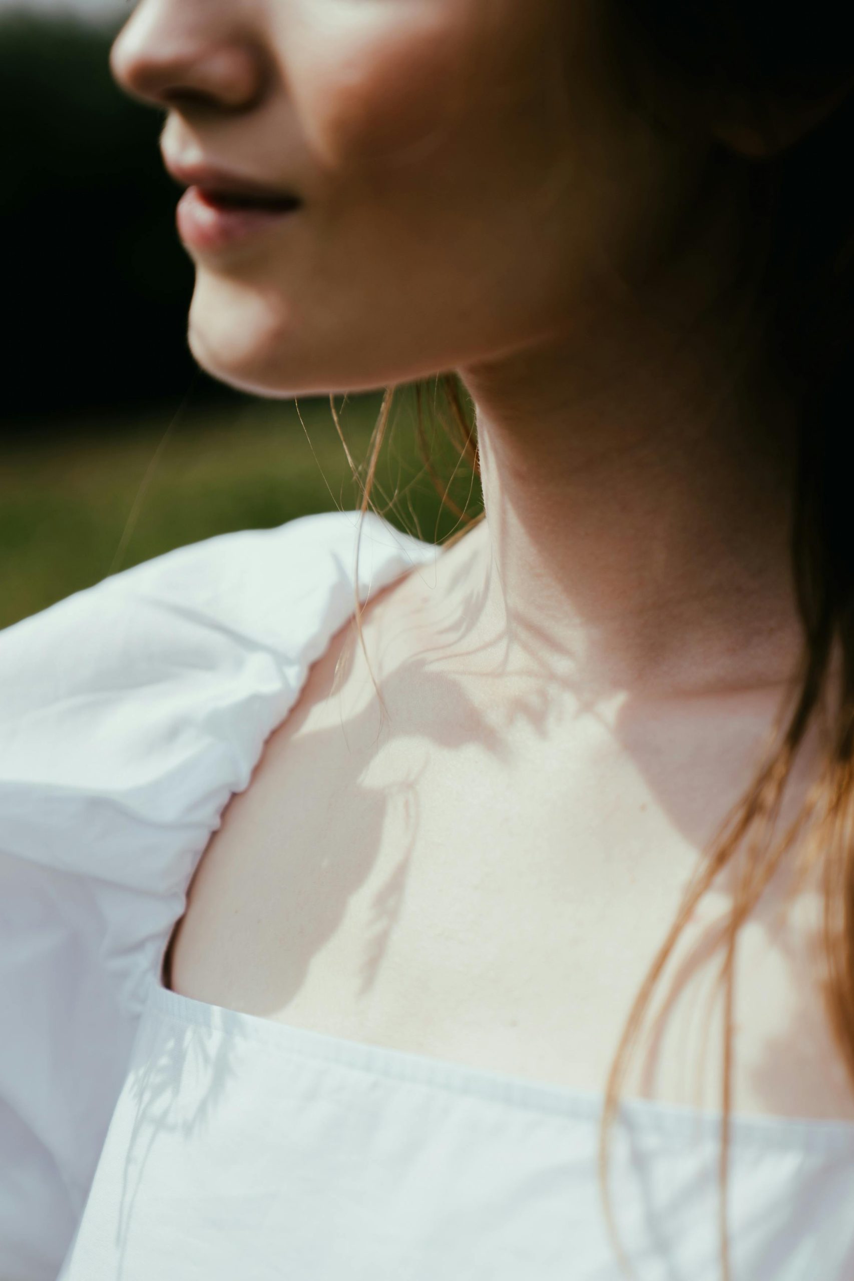 Neckline view of woman wearing white cotton dress